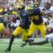 Michigan quarterback Devin Gardner dodges a tackle during the first quarter of their game against Central Michigan, Saturday, Aug, 31.
Courtney Sacco I AnnArbor.com  